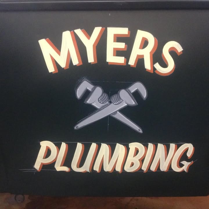 Hand-painted Myers Plumbing sign: cream lettering and two crossed pipe wrenches on black